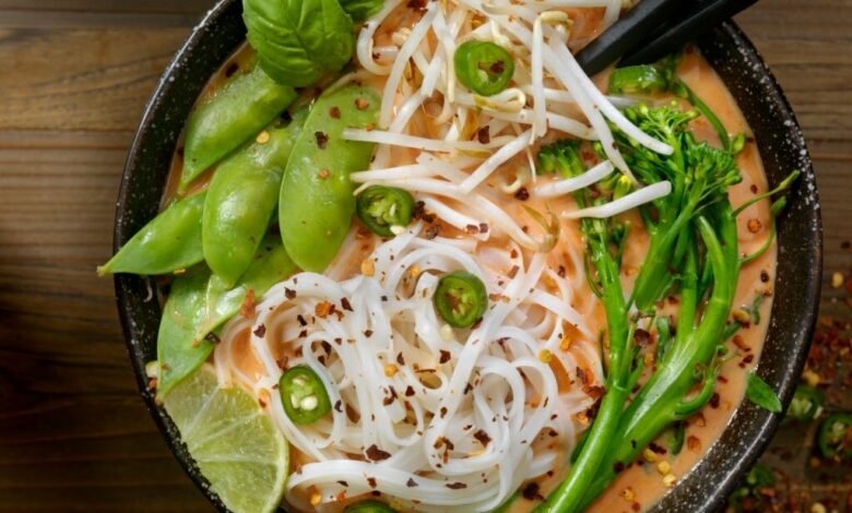 https www.istockphoto.comphotored curry noodle soup with broccolini bean sprouts and fresh basil gm914644496 251732828